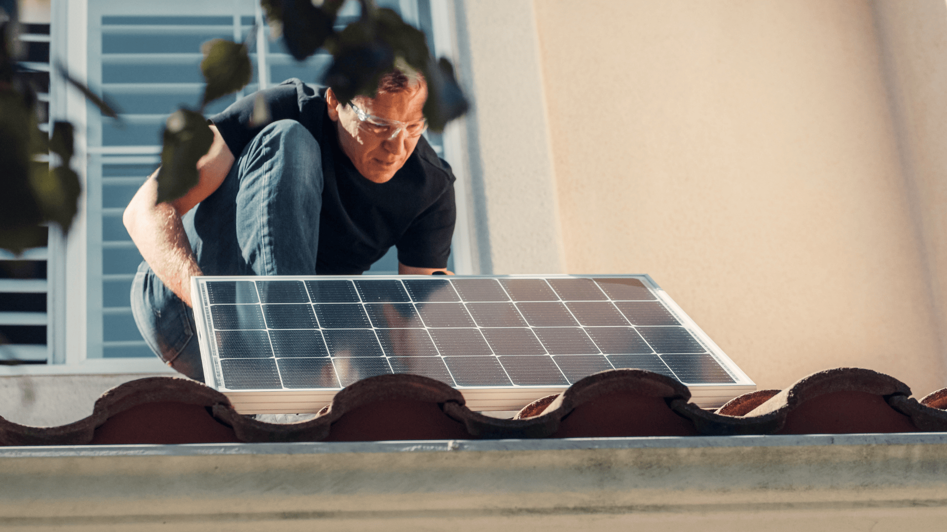 Installer mounting a solar panel on a residential roof