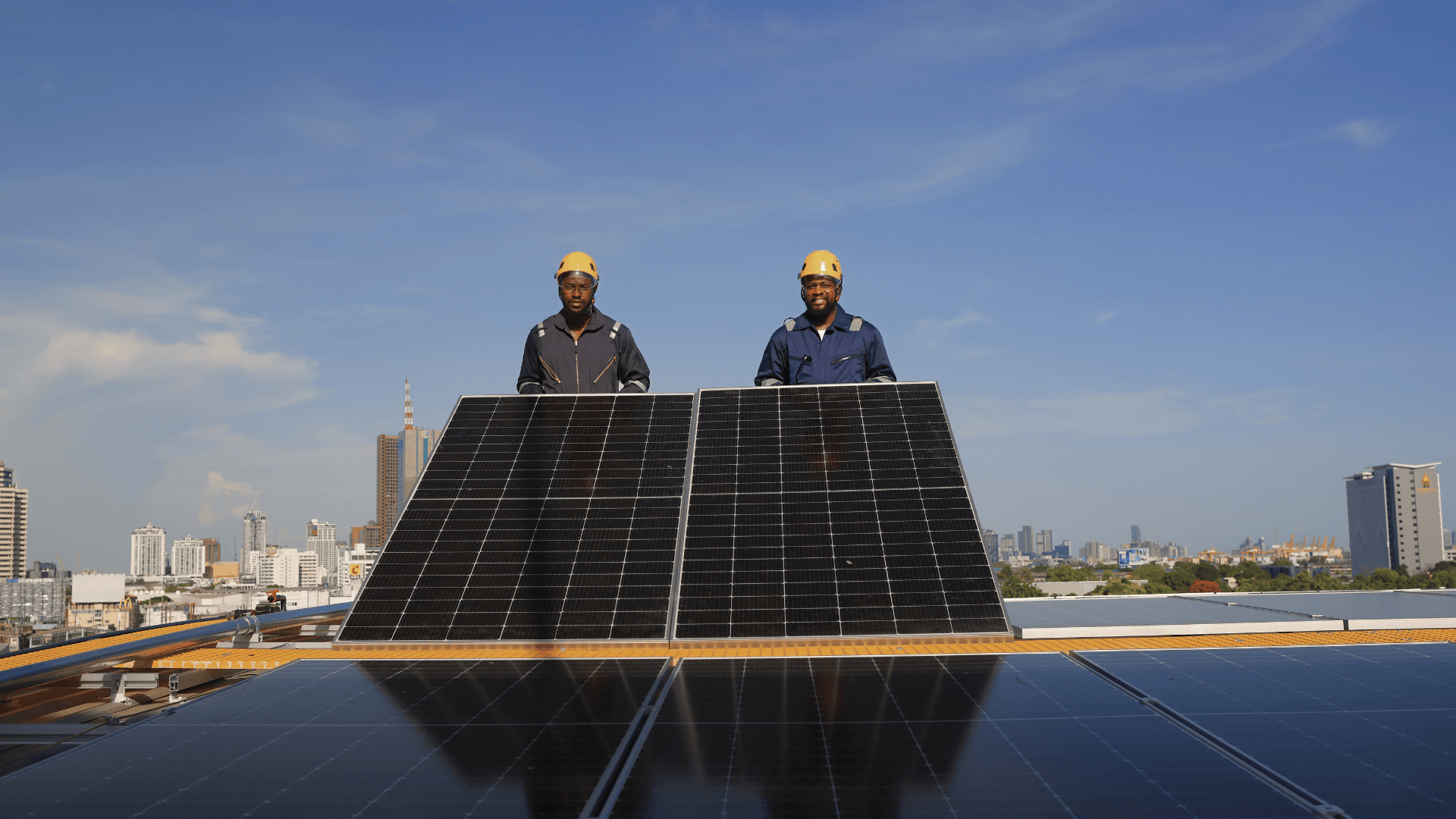 Solar technicians installing panels on a rooftop